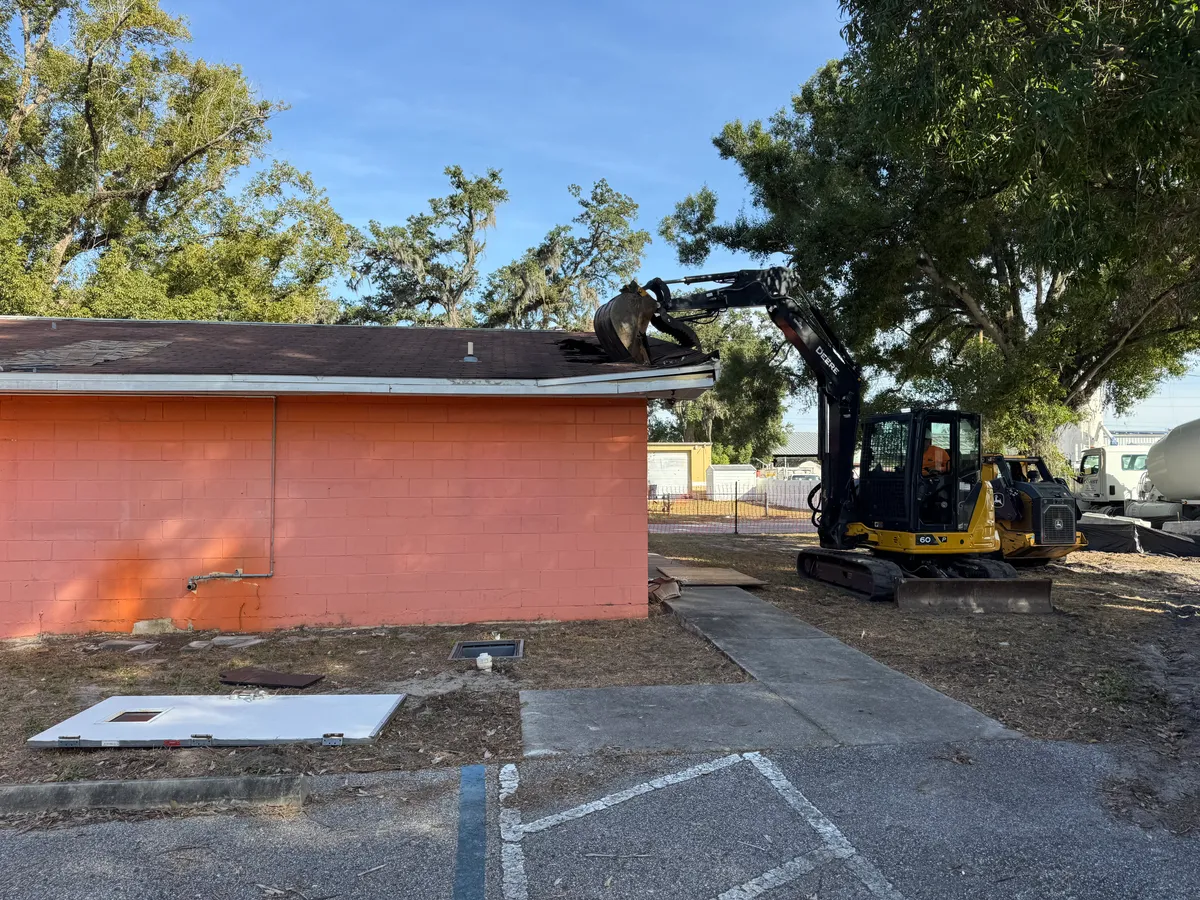 Excavator performing demolition
